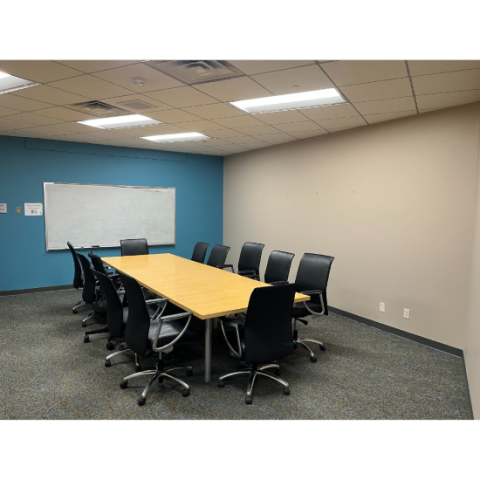 Room with a conference table and 12 chairs.