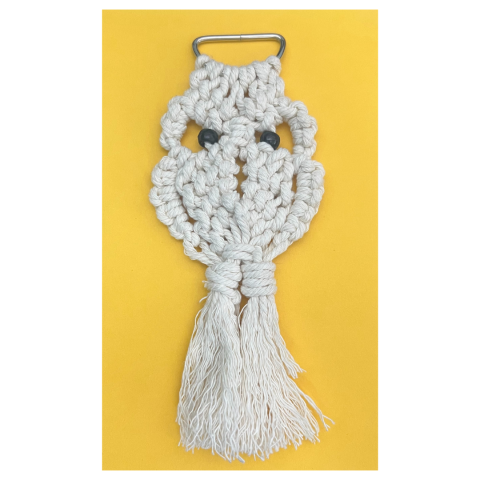 white macrame owl on a yellow background