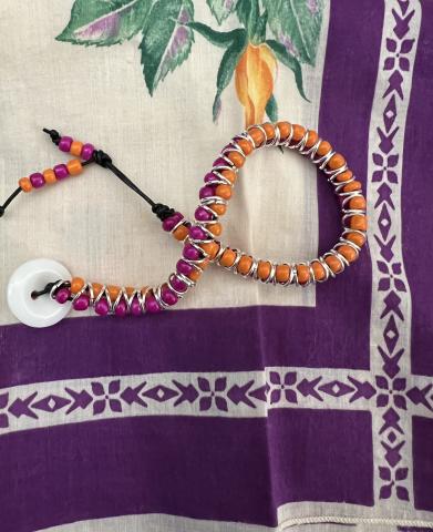 orange and purple bracelet on a white and purple background